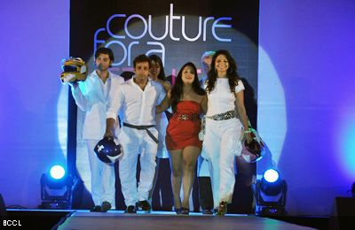 Abhishek Awasthi L and Akruti Mistry walk the ramp with designer Aarti Vijay Gupta C during the latters show Couture For A Cause at ITC Maratha in Mumbai